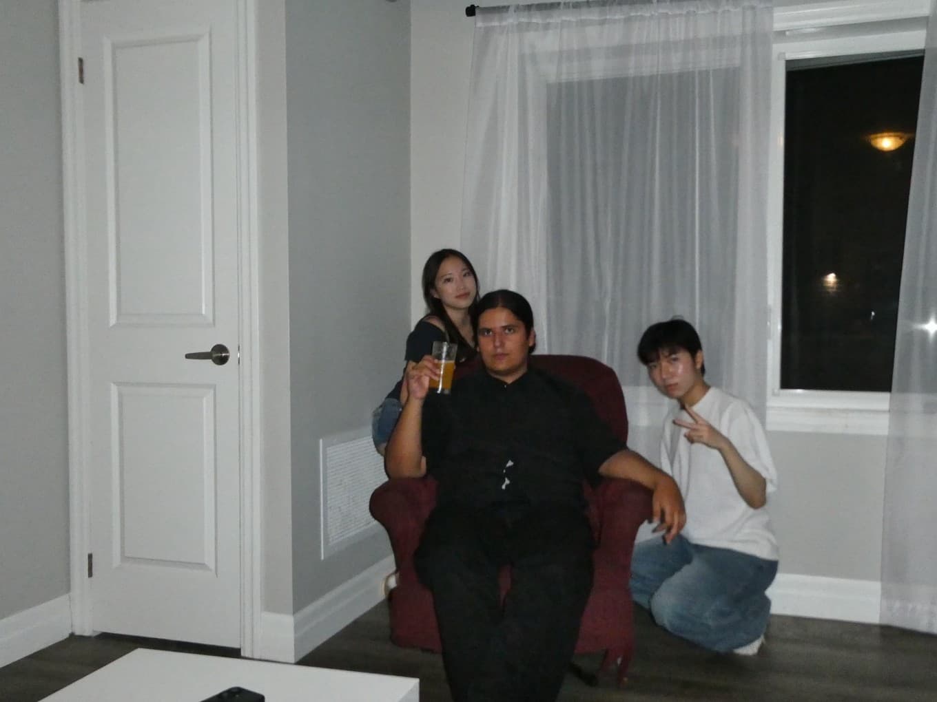Lucas with friends on a red armchair