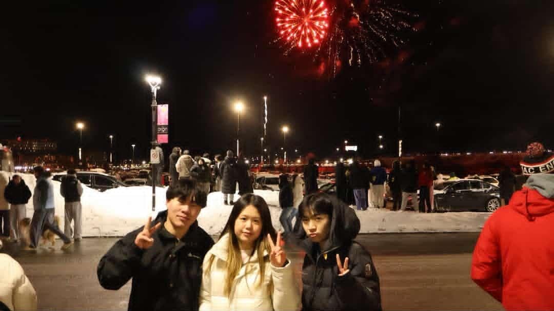 Lucas with friends under fireworks