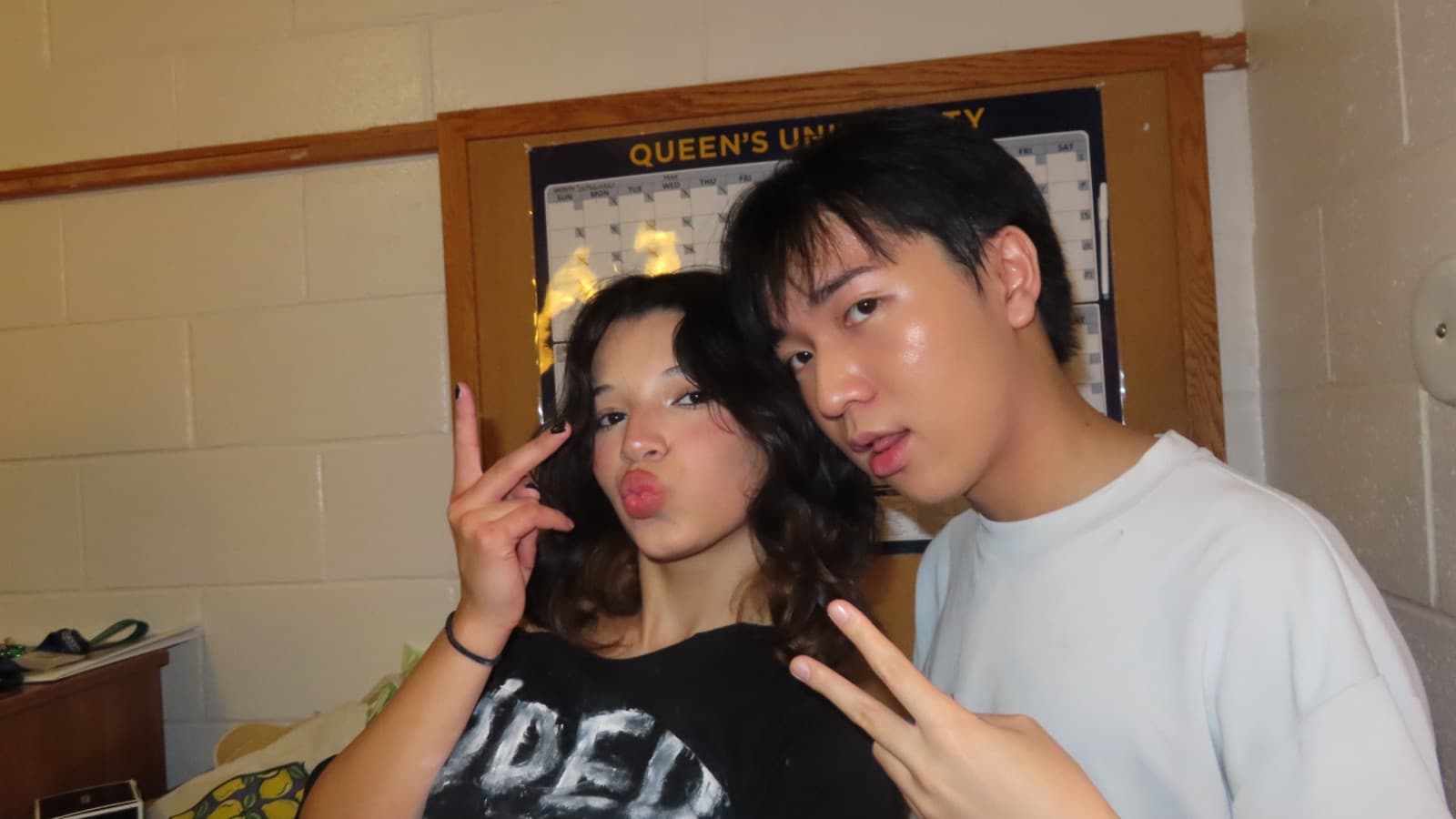 Lucas and a friend in a dorm hallway