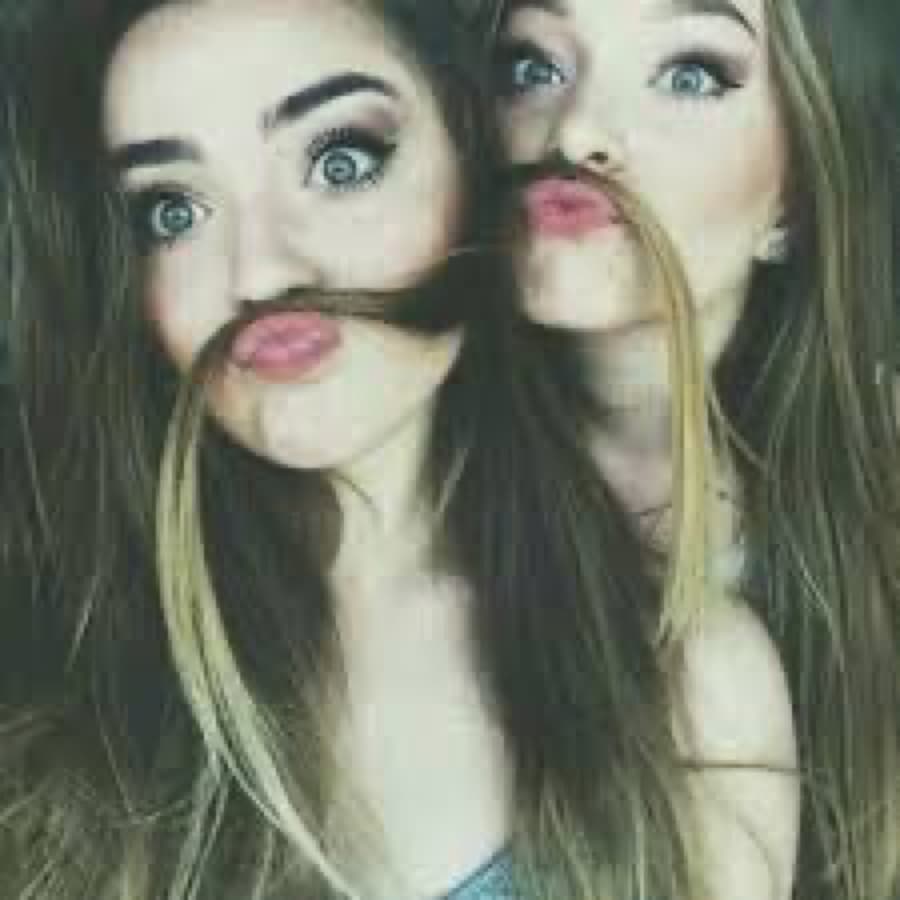 Two friends making hair moustaches